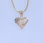 Diamond set heart pendant made with 9ct reticulated gold