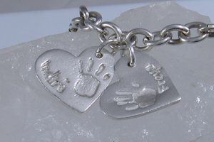 Personalised silver jewellery with hand print and name